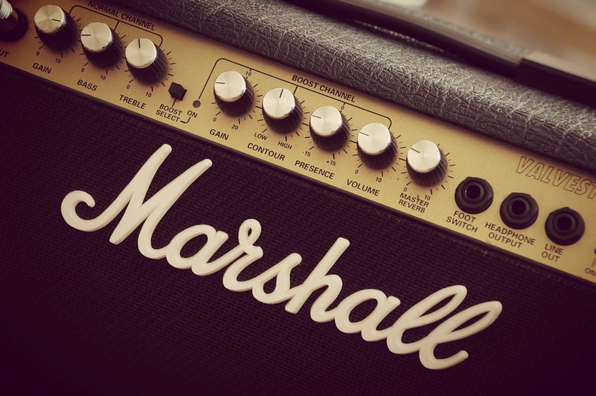A high-gain amplifier head lit on a dark stage