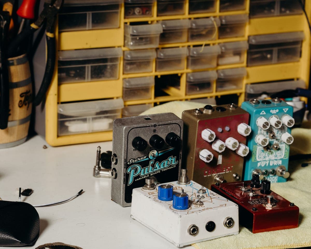 Several vintage-style guitar pedals arranged on a workbench