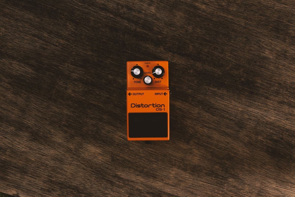 Compact budget guitar pedals lined up on a plain surface