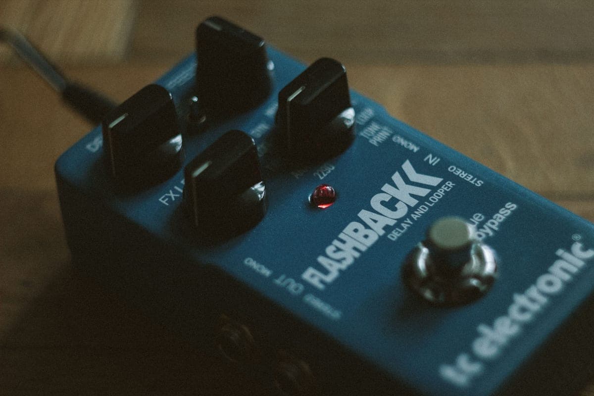 A delay pedal and patch cables photographed from above