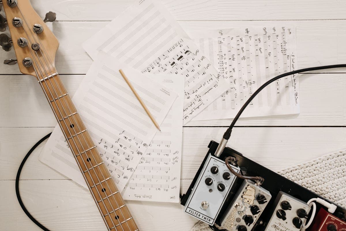 A green overdrive pedal photographed close on a wooden floor