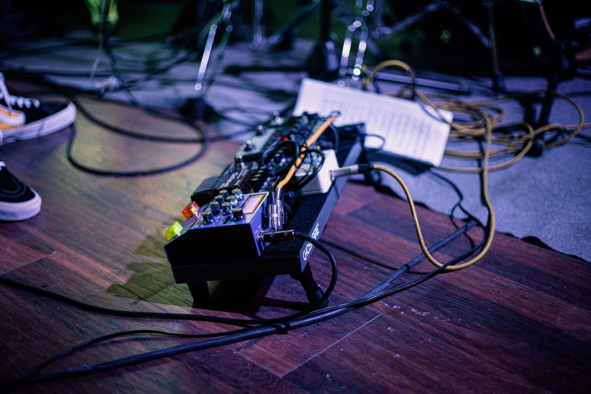 A pedalboard with several pedals and cabling seen from above