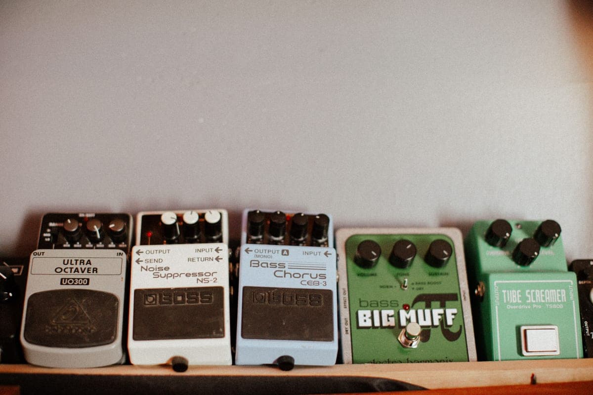 Three overdrive pedals arranged on a wooden surface